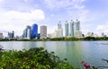 Bangkok, Thailand - August 18, 2018 : Lake Ratchada situated in the Benjakitti Park with flowers in the foreground and modern Royalty Free Stock Photo