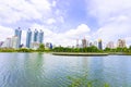 Bangkok, Thailand - August 18, 2018 : Lake Ratchada situated in the Benjakitti Park with flowers in the foreground and modern Royalty Free Stock Photo