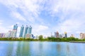 Bangkok, Thailand - August 18, 2018 : Lake Ratchada situated in the Benjakitti Park with flowers in the foreground and modern Royalty Free Stock Photo