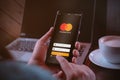 Bangkok, Thailand - August 6, 2019: Mastercard crypto wallet concept. Hands holding Smartphone with Mastercard log on screen. Royalty Free Stock Photo