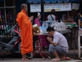 Bangkok, Thailand - August 16, 2017: monks walking on the street to collect alms and offerings in the morning for alms gathering