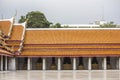 Bangkok, Thailand - 30 August 2020: orange traditional thai temple roof where is black buddha sculptures are arranging indoor Royalty Free Stock Photo