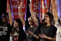 Protesters leader a three finger salute to show symbolic gestures.