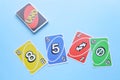 Bangkok, Thailand : August 13, 2023 : A set of colorful Uno game cards on light blue background. Royalty Free Stock Photo