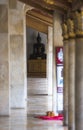 Bangkok, Thailand - 30 August 2020: thai black buddha sculpture at the end of walkway in thai temple