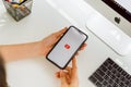 Bangkok, Thailand - August, 2020 : woman hand is pressing the screen displays the Youtube app icons on Apple iPhone.