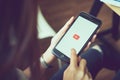 Bangkok, Thailand - August 23, 2017 : woman hands holding apple iPhone 6s on screen displays the Youtube app on the touch screen. Royalty Free Stock Photo