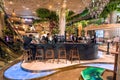 Bar counter with bartenders inside luxury hall of urban shopping mall with great decorations