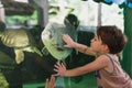 Bangkok, Thailand: a child touches a fish at Dusit Zoo