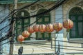 Chinese lanterns in the electric cables across the street. Travel around Asia.