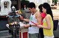 Bangkok, Thailand: Couple Lighting Incense Sticks