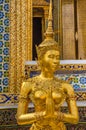 Golden statue of a kinnara in the temple of the Emerald Buddha, Bangkok