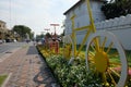 Decorative, multi-colored bicycles stand on a city street during the day