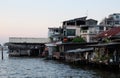 Many shacks and stilt houses are located on the banks of the Chao Phraya River. Asian slum