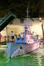 Model of a warship among the artificial pond at night