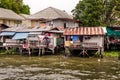 Wooden slums on stilts on the riverside of Chao Praya River in Bangkok Royalty Free Stock Photo
