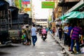 Bangkok, Thailand, December 26, 2019: People on mopeds and vendors selling street food on skewers in Bangkok Thailand.