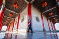 Bangkok, Thailand - December, 20, 2021 :People walking on constricted of beside main building with Stone carving on the wall and