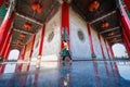 Bangkok, Thailand - December, 20, 2021 :People walking on constricted of beside main building with Stone carving on the wall and