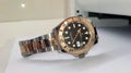 Rolex Yacht-Master with rose gold bezel and two tone rolesor strap on the table