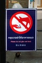 Sign warns people against feeding the cats in Bangkok, Thailand