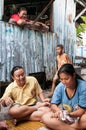 Thai women play money on cards in the slum of KLong Toey in Bangkok. Money games are prohibited in Thailand.