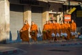 Young Buddhist monks return to the monastery with collected food