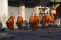 Young monks return to the monastery after morning food gathering