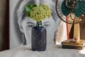 Bouquet of flowers in Blue ceramic vase and vintage fan on white textured table cloth in front of Classic chinese poster movie