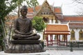 Buddha statues sit under the tree in Mable Temple in Bangkok