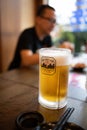 Cold Asahi beer mug on a dark brown wooden table in a Japanese izakaya restaurant