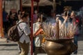 Incense burning with white smoke in an incense pot at a temple in Wat Mangkon Kamalawat