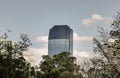 View of Modern high buildings among green trees space in nature against blue sky with clouds at afternoon Royalty Free Stock Photo