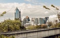 View of Modern high buildings and walkway bridge among surrounded green trees space Royalty Free Stock Photo