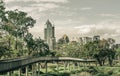 View of Modern high buildings and walkway bridge among surrounded green trees space Royalty Free Stock Photo