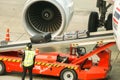 Closeup staff of Thai Air Asia airline using baggage loader cart loading luggage Royalty Free Stock Photo