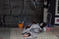 Homeless man sleep on cold tile of pedestrian area