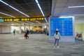 BANGKOK, THAILAND - FEBRUARY 01, 2018: Indoor view of unidentified woman checking departures flights in an informative