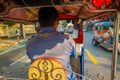 BANGKOK, THAILAND, FEBRUARY 08, 2018: Inside viuew of unidentified man driving a three-wheeled tuk tuk taxi in a road in Royalty Free Stock Photo