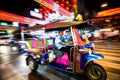 Bangkok, Thailand - February 2018: A motion blurred view of a tuk-tuk taxi in the streets of China town. Royalty Free Stock Photo