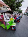 At Bangkok , Thailand - February 24,2024 : Multi-colored tuk-tuks lined up in side streets.