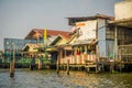 BANGKOK, THAILAND, FEBRUARY 08, 2018: Outdoor view of unidentified people over a wooden old building house, located at Royalty Free Stock Photo