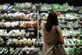 Bangkok, Thailand - February 7, 2022 : single asian woman shopping and buying vegetables to cook dinner food after work at local s Royalty Free Stock Photo