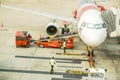 Staff of Thai Air Asia airline using baggage loader cart loading luggage to the airplane Royalty Free Stock Photo