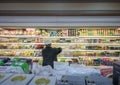 BANGKOK, THAILAND - FEBRUARY 19: Unnamed employee rearranges inventory on the refrigerated shelf in Foodland supermarket in