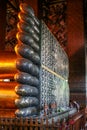 A feet of the Golden statue in Wat Pho, front view. Interior of the Temple of the Reclining Buddha. Famous sights of Bangkok.