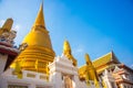 Bangkok, Thailand. Golden stupa on the background of blue sky. Royalty Free Stock Photo