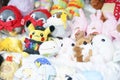 A photo of a lot of cute plush dolls with selective focus on pikachu doll wearing Pokemon Gym