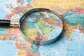 Bangkok, Thailand - January 20, 2022 Asia, Magnifying glass close up with colorful world map, travel, geography, tourism and