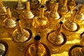 Asian Buddha holy water in small golden brass vase pot for Buddhist people pray and pouring wat